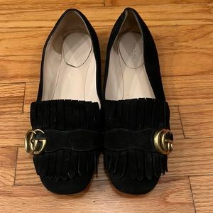 Gucci black suede loafers with gold logo.